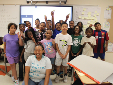 group of students smiling with a woman